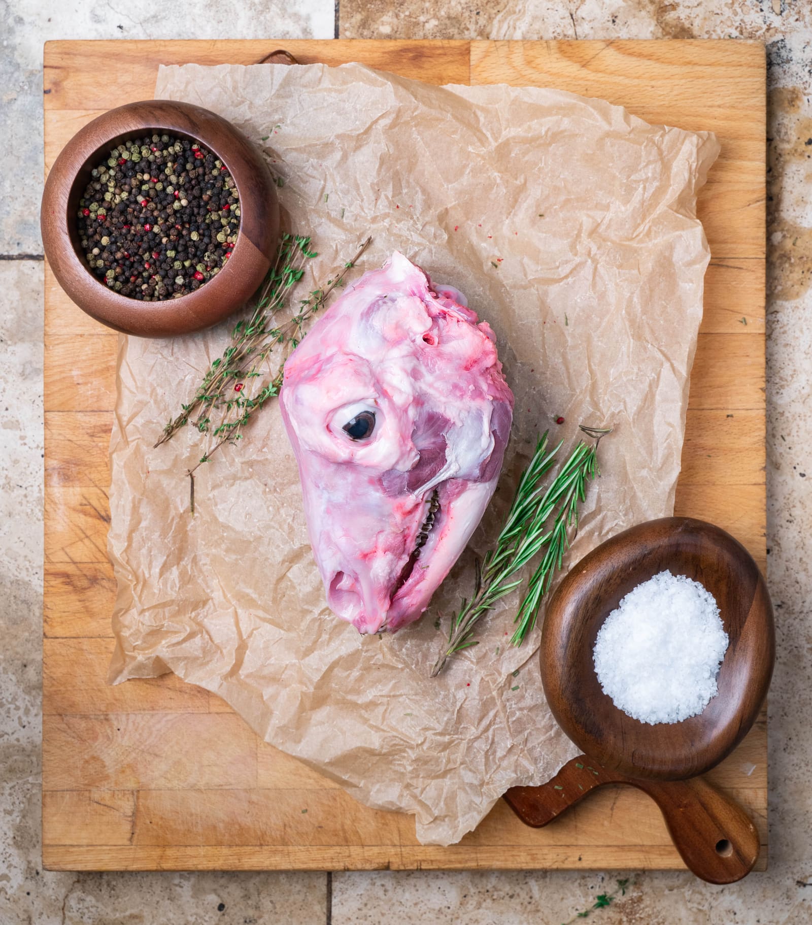 Skinned lamb head with rosemary, peppercorns and sea salt